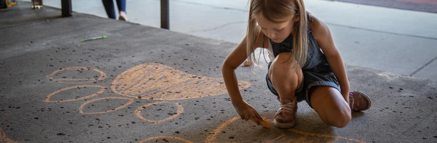 Walnut Street School Student Drawing with Sidewalk Chalk 
