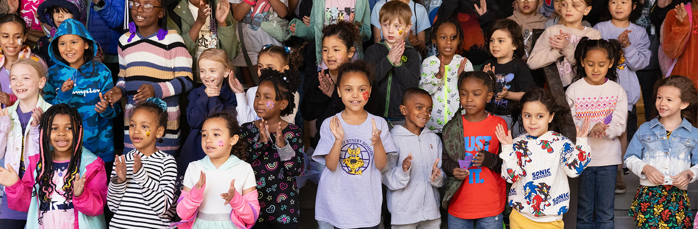 students singing and clapping